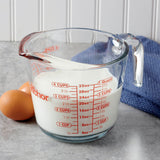Anchor Hocking glass measuring cup with measurement markings for accurate liquid and ingredient measurement.