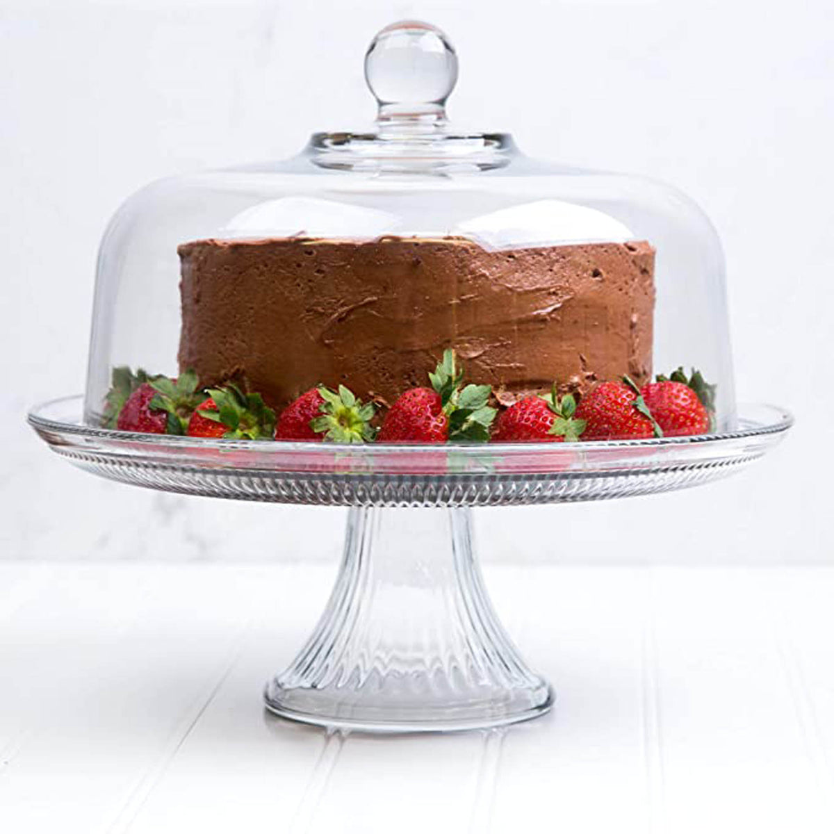 Anchor Hocking Kuchenplatte, clear glass cake stand with a wide flat surface and decorative scalloped edges for serving desserts.