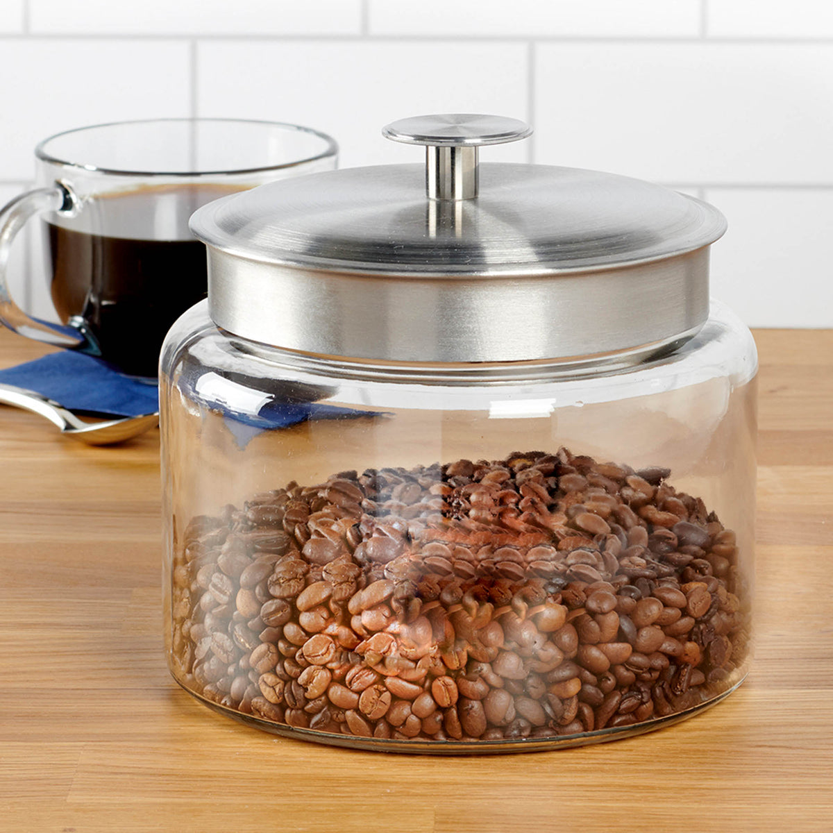 Anchor Hocking Montana storage jar with clear glass body and white screw-top lid for kitchen pantry organization.