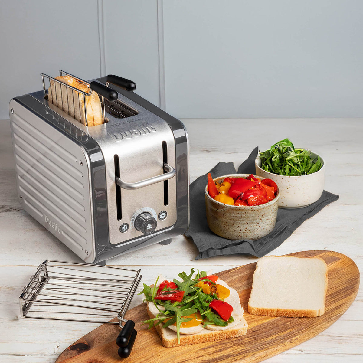 Dualit Lite stainless steel sandwich maker with open plates and compact design for quick, even toasting.