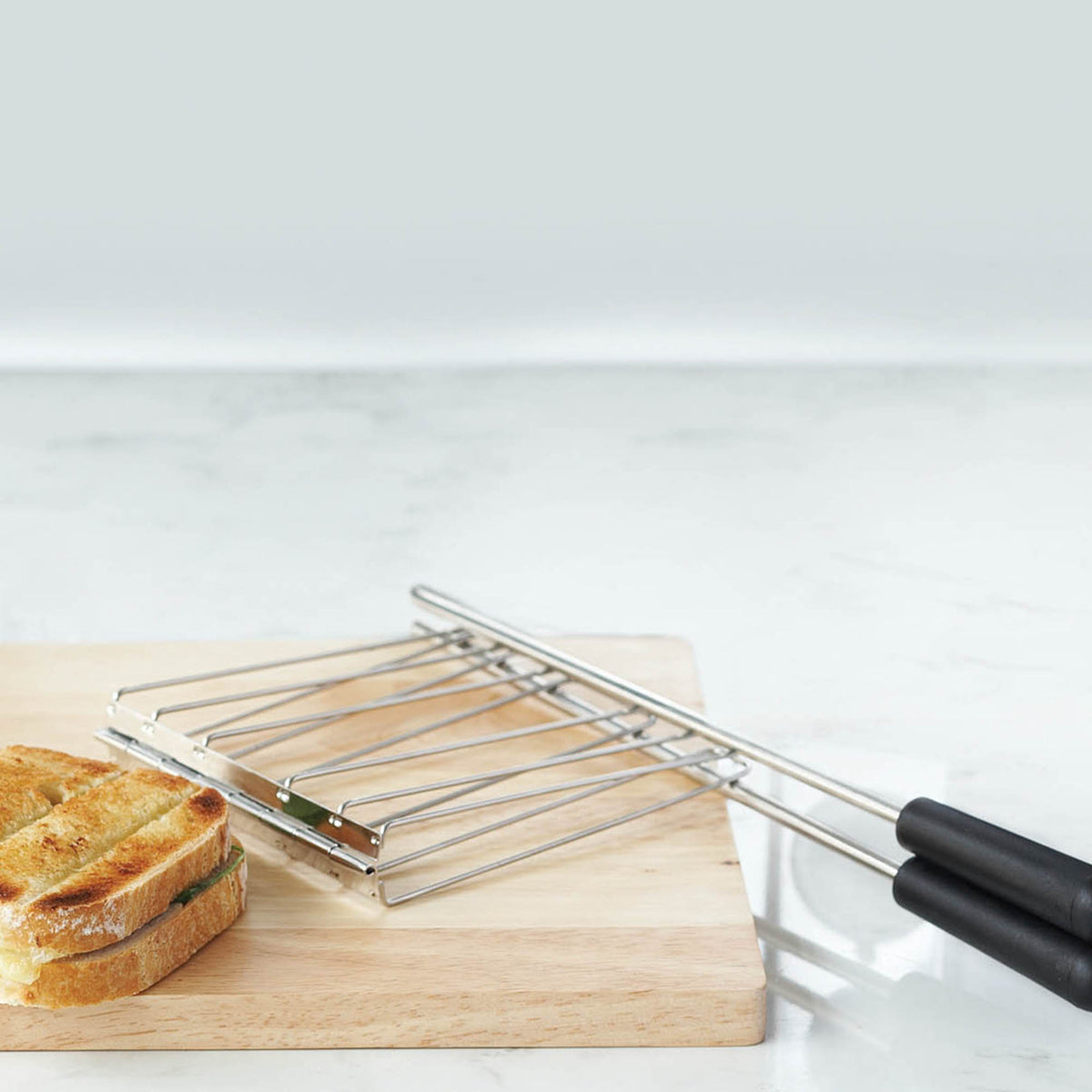 Dualit Classic stainless steel toaster with two slots for toasting bread slices, compact and stylish kitchen appliance.