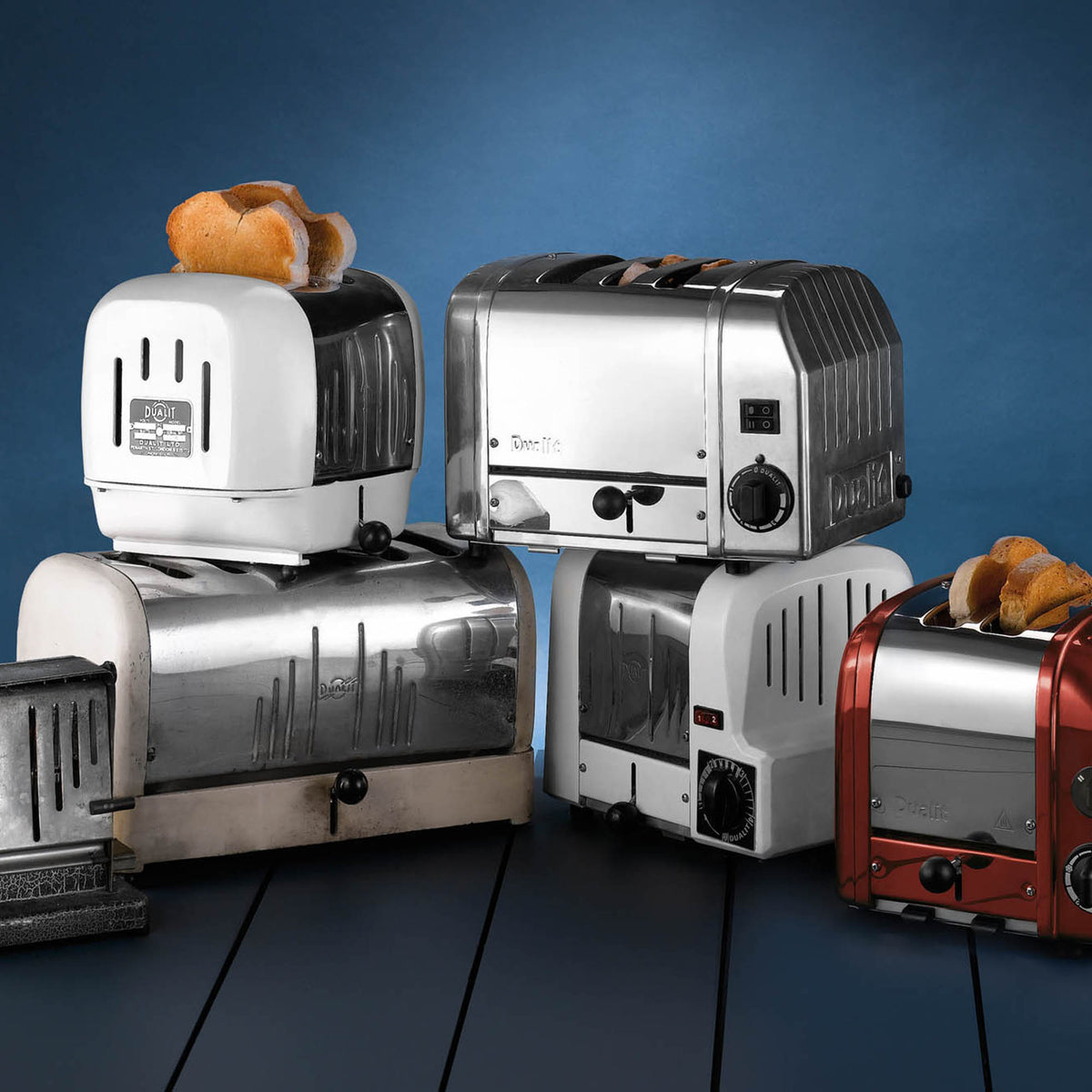 Dualit NewGen toaster with red finish, 2-slice capacity, featuring modern design and stainless steel accents.