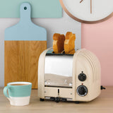 Dualit Newgen creme toaster with two slots, stylish kitchen appliance for toasting bread and snacks.