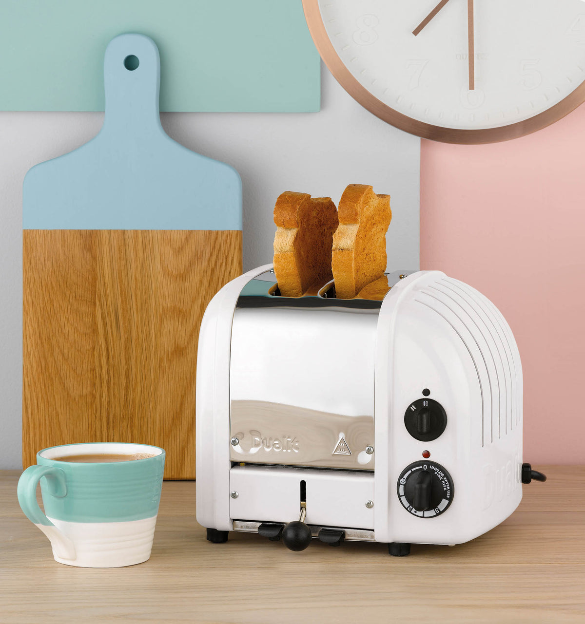 Dualit NewGen white 2-slice toaster with sleek design and control dials, perfect for toasting bread and bagels.