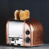 Dualit NewGen copper toaster with two slots for bread, featuring a sleek modern design and adjustable browning control.