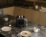Dualit NewGen black 2-slice toaster with modern design and control buttons, perfect for quick, even toasting.