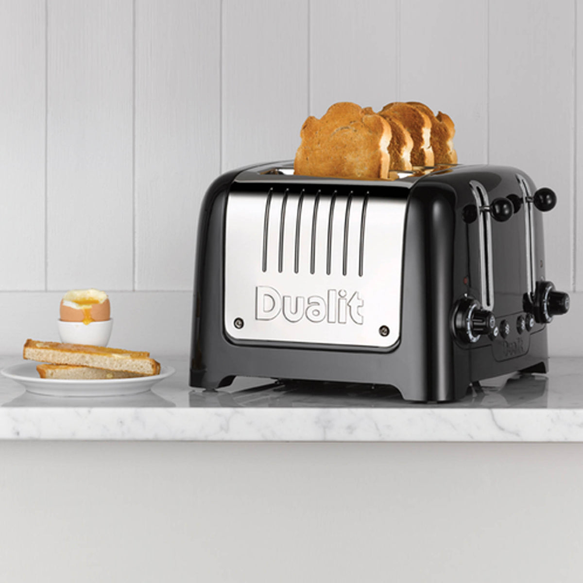 Dualit 2+1 Combi Toaster in black with two slots and one wide slot for toasting bread and bagels.