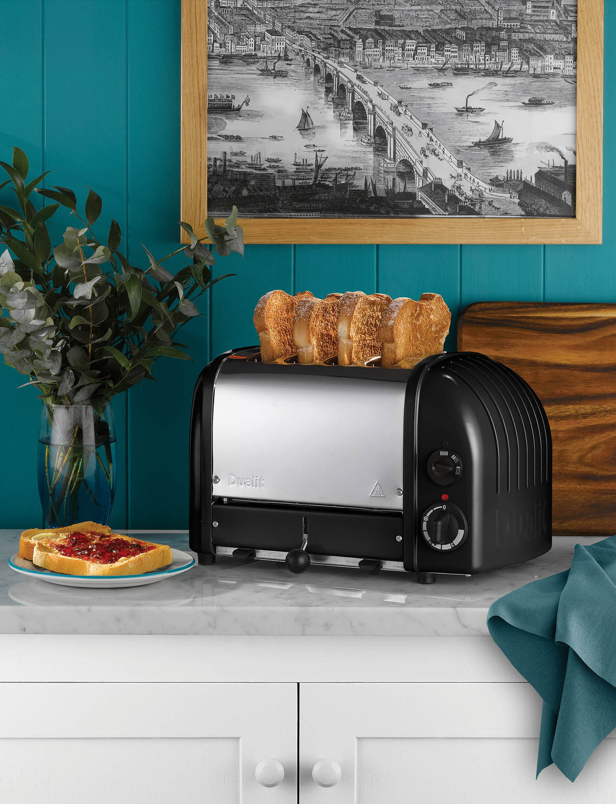 Dualit Newgen black 4-slice toaster with modern design and control knobs, designed for even toasting and durability.