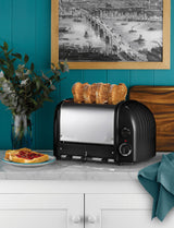 Dualit Newgen black 4-slice toaster with modern design and control knobs, designed for even toasting and durability.
