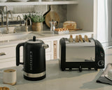 Dualit Newgen black 4-slice toaster with sleek design and modern controls, ideal for toasting bread and bagels.