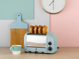 Dualit Newgen blue 4-slice toaster with modern design, featuring four toasting slots and control knobs.