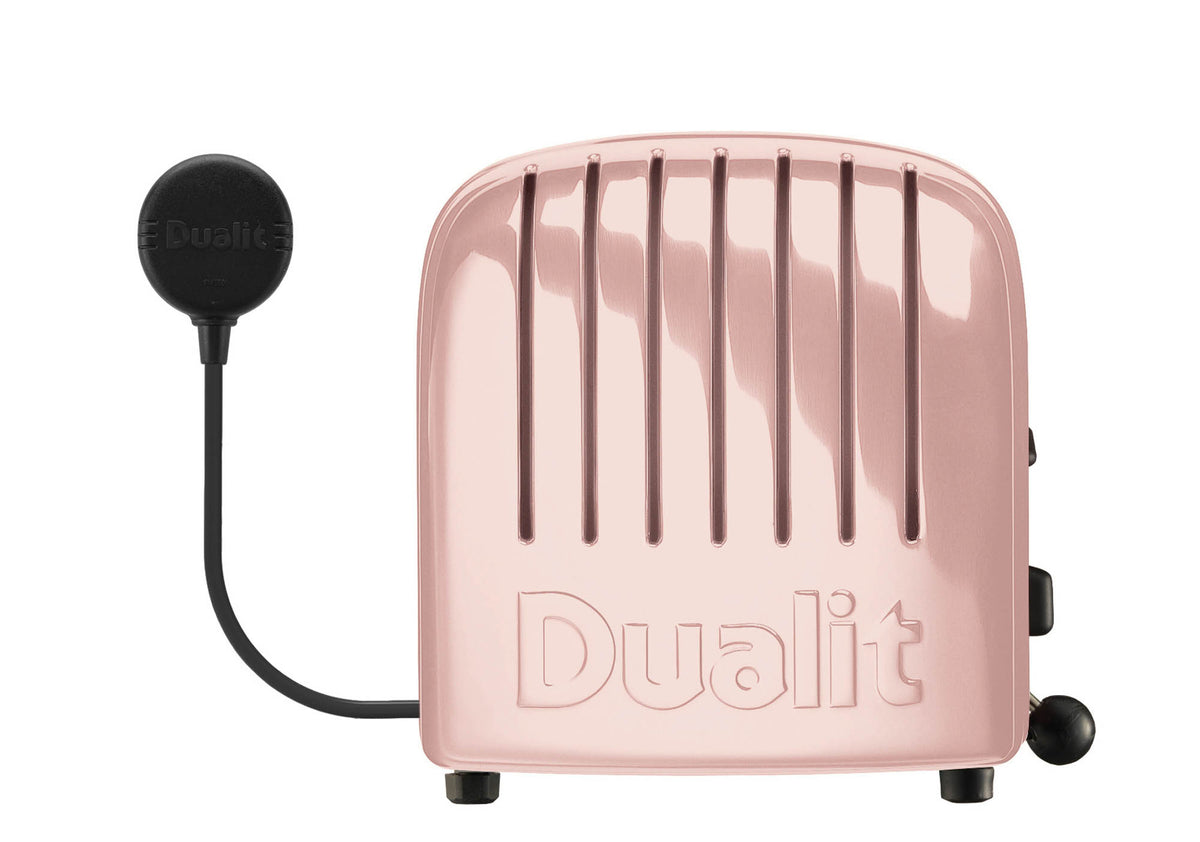 Dualit Newgen pink 4-slice toaster with modern design, featuring control knobs and slots for toasting bread.