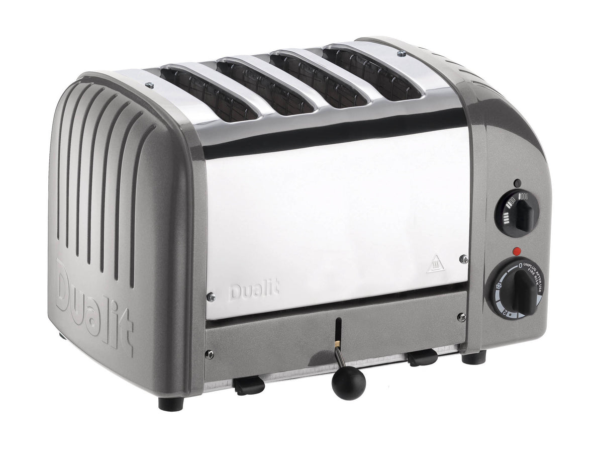 Dualit NewGen silver metallic 4-slice toaster with modern design and stainless steel finish, shown with bread inside.