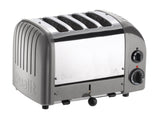 Dualit NewGen silver metallic 4-slice toaster with modern design and stainless steel finish, shown with bread inside.