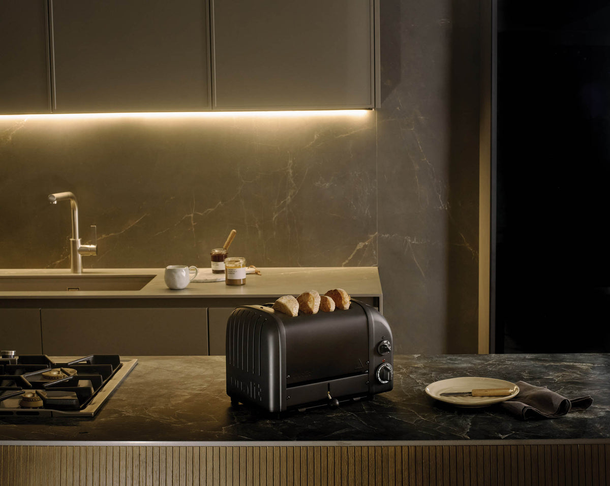 Dualit Newgen black 4-slice toaster with modern design and visible control buttons for easy toasting.