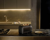 Dualit Newgen black 4-slice toaster with modern design and visible control buttons for easy toasting.