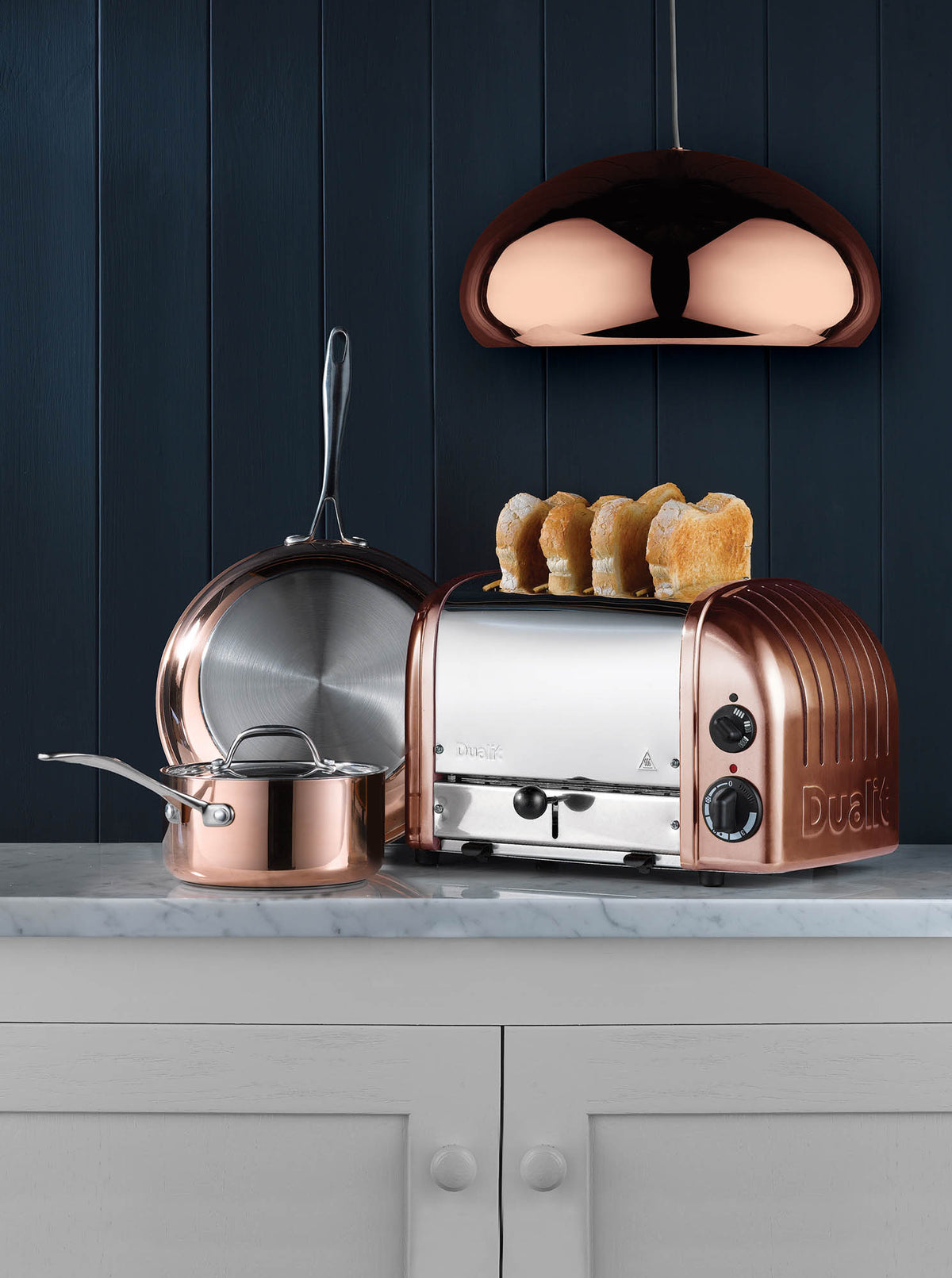 Dualit Newgen copper 4-slice toaster with modern design and control knobs, visible in the image.