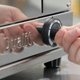 Dualit Gastro black pop-up toaster with chrome finish, featuring two slots for toasting bread and bagels.