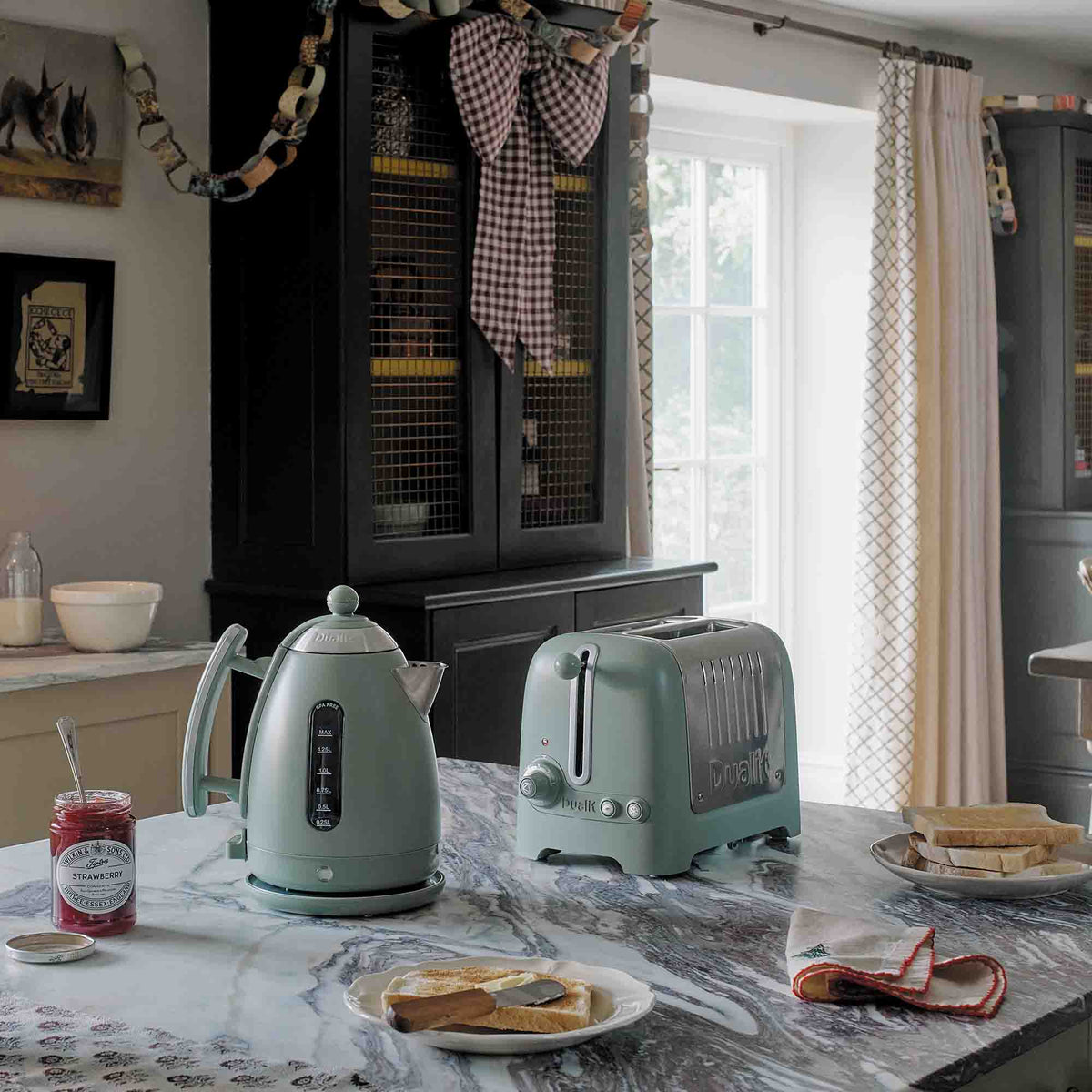Dualit LITE electric kettle in sage green with 1.5-liter capacity, featuring a sleek design and modern handle.