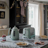 Dualit LITE electric kettle in sage green with 1.5-liter capacity, featuring a sleek design and modern handle.