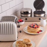 Polished DUALIT contact toast and waffle iron for catering, shown with its stainless steel surface and cooking plates.