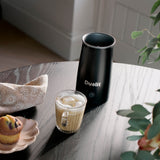 Dualit milk frother for milk and chocolate in black, compact electric milk frother with textured black finish.