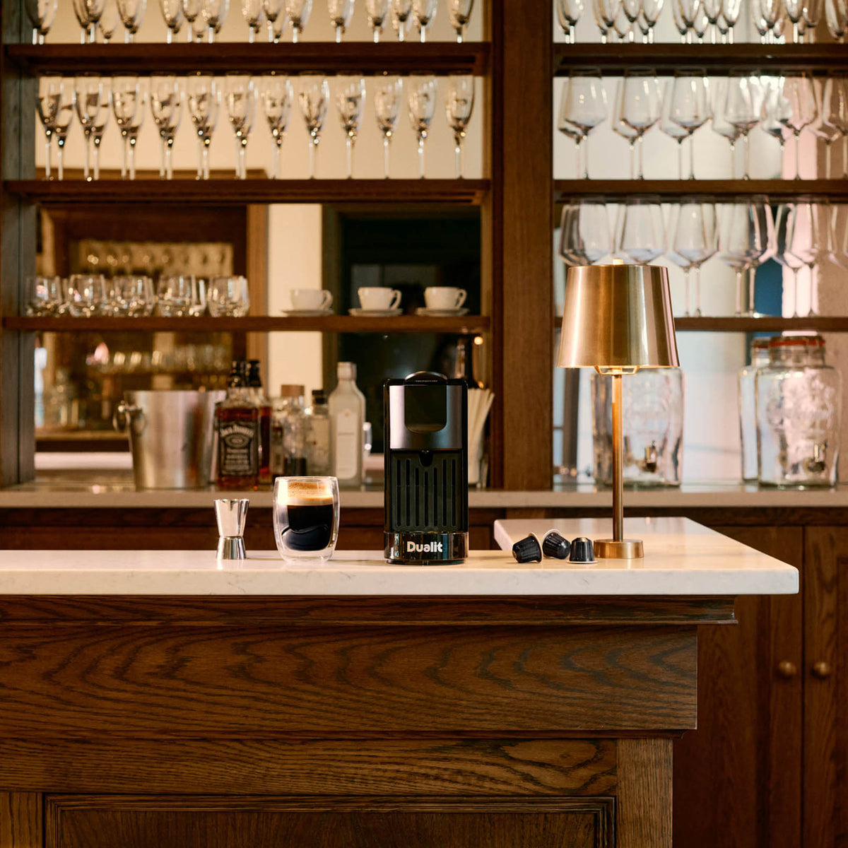 Dualit coffee capsule machine in black, 34 cm tall, compact espresso maker with sleek design and easy capsule operation.