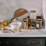 Dualit Classic copper hand mixer with beaters and control buttons, compact and stylish kitchen appliance.