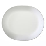 Corelle Winter Frost white dinnerware set with plates and bowls featuring a frosted snowflake design on a white background