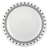 White CORELLE City Block dinnerware set with plates and bowls arranged on a table, showcasing modern ceramic design.