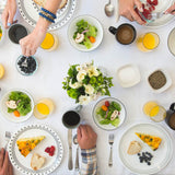 Corelle City Block white dinnerware set with plates and bowls arranged on a wooden table, showcasing modern, durable ceramic dishes.