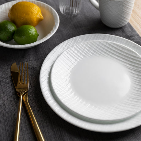 Corelle white Linen Weave dinnerware set featuring elegant, textured ceramic plates and bowls for stylish table setting.