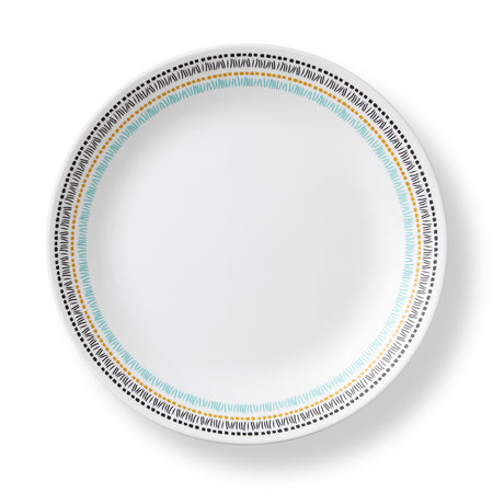 Corelle Paloma white dinnerware set with colorful graphic design, featuring plates and bowls arranged on a table.