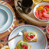 Corelle Paloma white ceramic dinnerware set with colorful graphic design on plates and bowls.