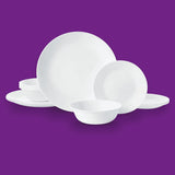 Corelle Winter Frost white dinnerware service with plates, bowls, and mugs arranged on a table.