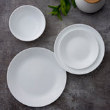 Corelle Winter Frost white dinner service with plates, bowls, and cups arranged on a table for elegant dining.
