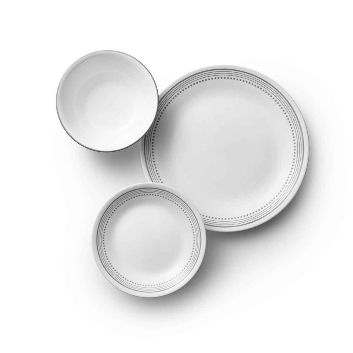 Corelle Mystic Gray dinnerware service set with white plates and bowls, featuring a modern gray and white design.