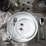 Corelle Mystic Gray dinnerware service with white plates and bowls, featuring a sleek, modern design for elegant table settings.