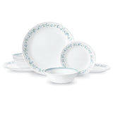 Corelle Country Cottage white dinnerware service set, featuring plates and bowls with a classic floral pattern on white ceramic.