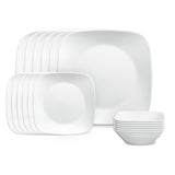 Corelle pure white dinner service with plates and bowls arranged on a table, showcasing sleek white ceramic tableware.