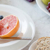 Corelle Winter Frost dinnerware set featuring white porcelain plates and bowls with a subtle frosted winter design.