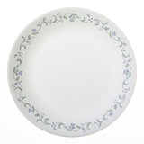 Corelle Country Cottage white dinnerware set with floral graphic design, showcasing plates and bowls for a cozy kitchen display.