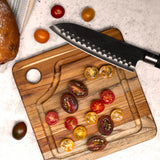 Teakhaus Marine teak wood cutting board with smooth surface and natural wood grain for kitchen use.