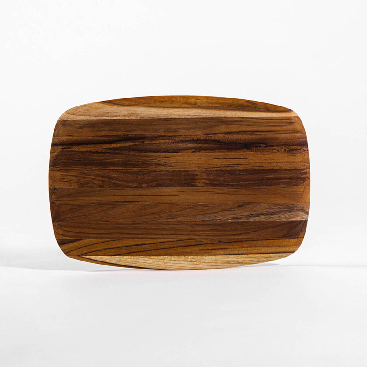 Teakhaus rectangular teak wood cutting board with elegant finish, ideal for food prep and serving on kitchen countertop.