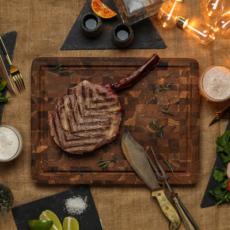 TEAKHAUS teak wood butcher block cutting board with a smooth surface and sturdy construction for kitchen use.