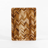 TEAKHAUS teak wood cutting board with herringbone pattern, ideal for kitchen prep and serving, made from durable teak wood.