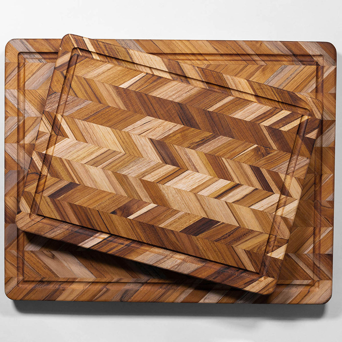 TEAKHAUS teak wood cutting board with herringbone pattern, ideal for preparing tea and kitchen tasks.