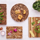 Teakhaus teak wood cutting board with herringbone pattern, ideal for kitchen prep and serving.