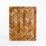 TEAKHAUS teakwood cutting board with herringbone pattern, ideal for kitchen food prep and serving.