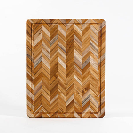 TEAKHAUS teakwood cutting board with herringbone pattern, ideal for kitchen food prep and serving.